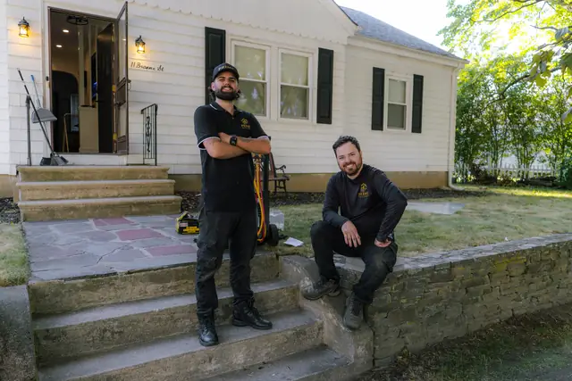 Prime technicians on the front steps of a home they serviced