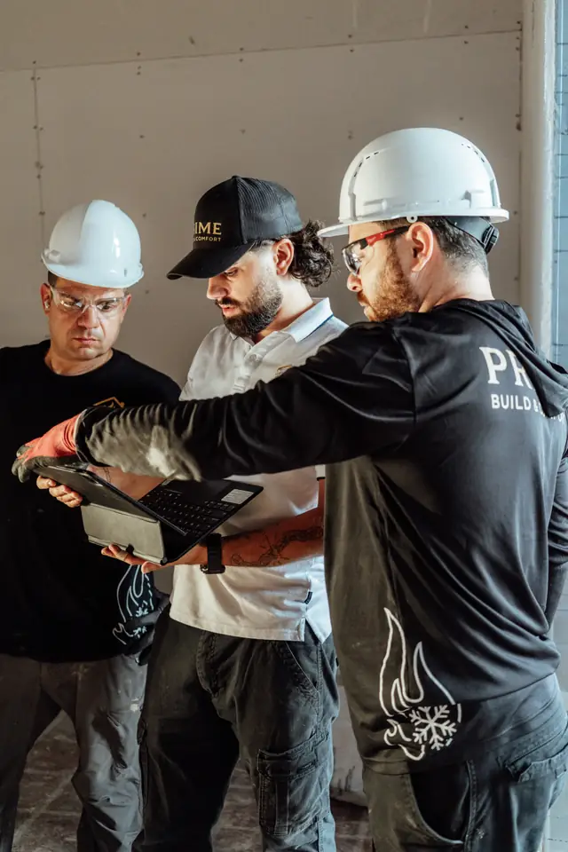 Prime crew reviewing plans on site