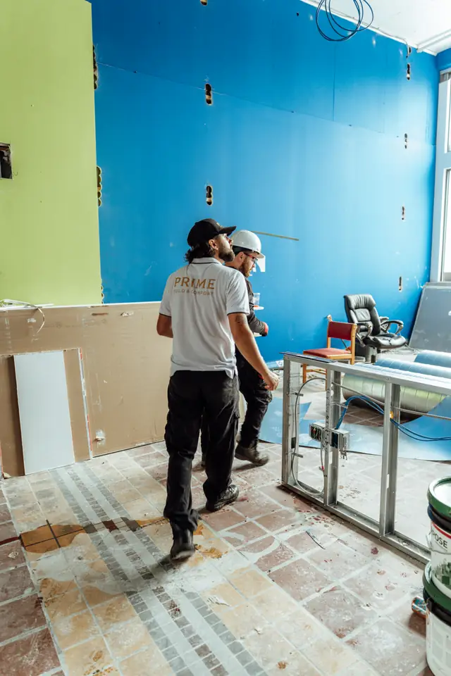 Technicians working inside a room during a remodel