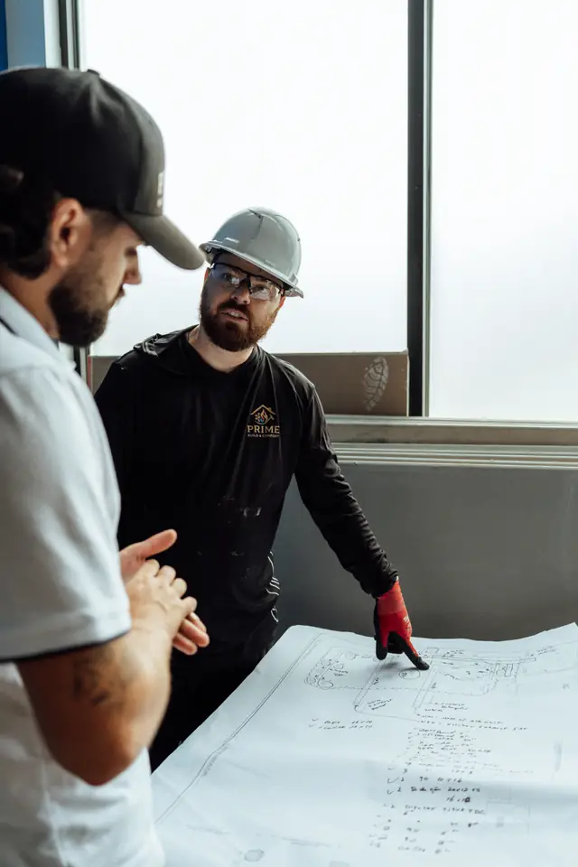 Prime technicians going over job blueprints