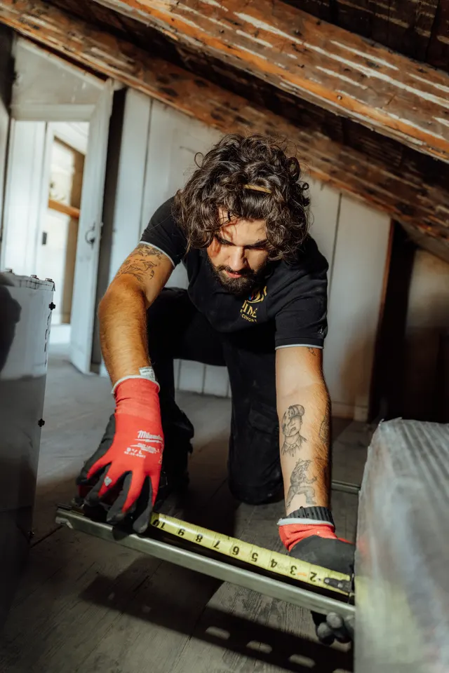 Prime technician measuring a mounting bracket for equipment support