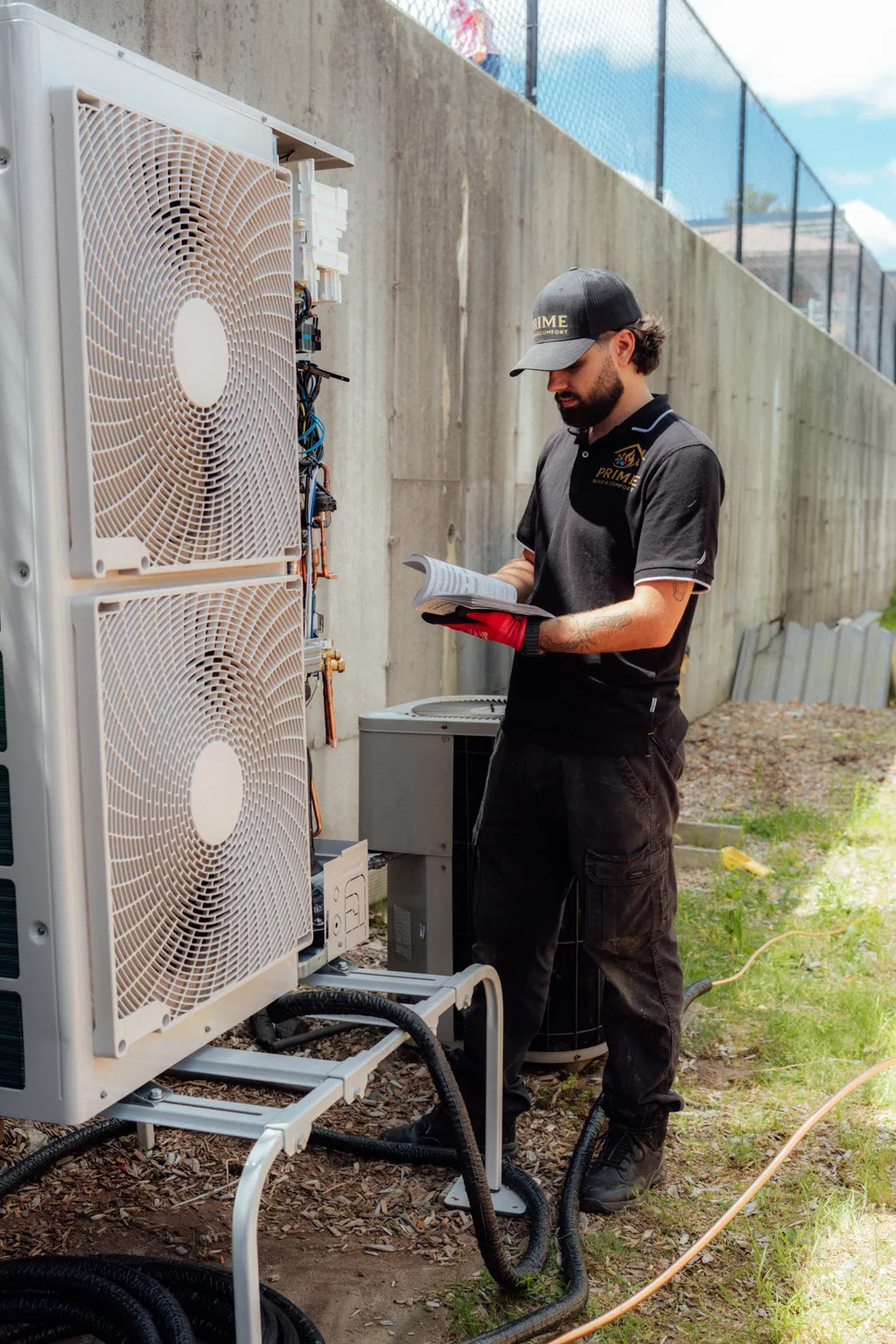 A Prime technician servicing an outdoor condenser unit