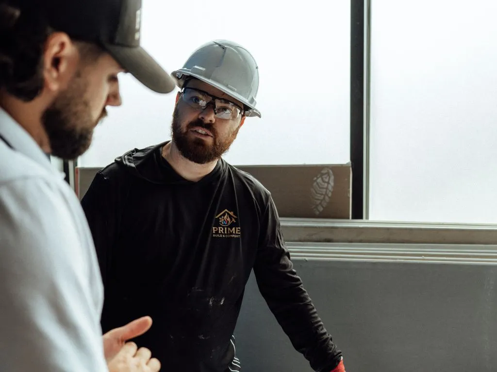 Prime crew reviewing project plans on a job site
